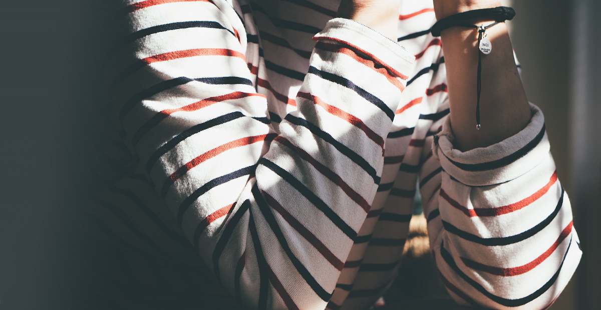 united states woman sitting wearing striped shirt bokeh